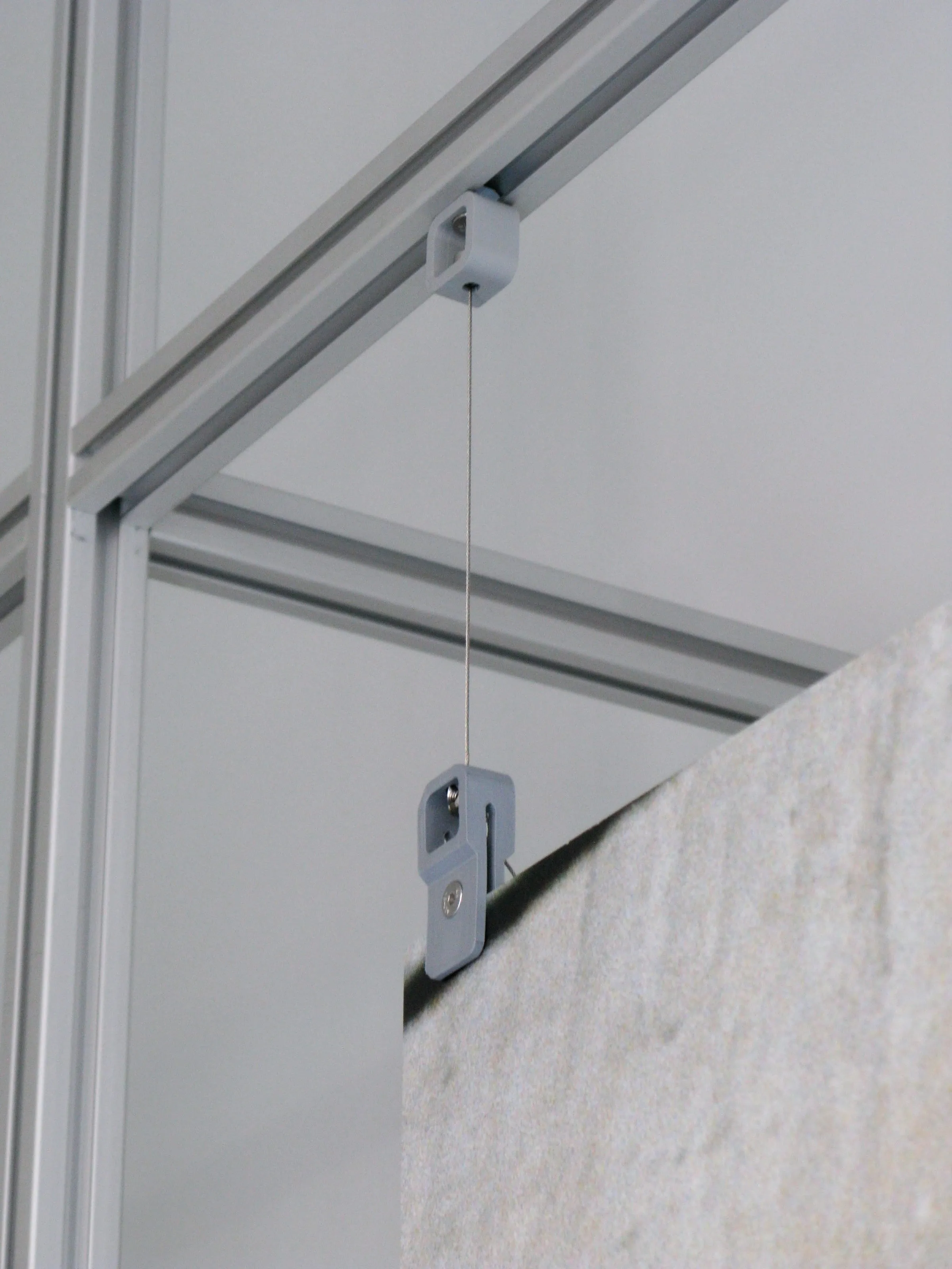 Steel cable with a clamp holding a print in the gallery, Analogue store Zeedijk