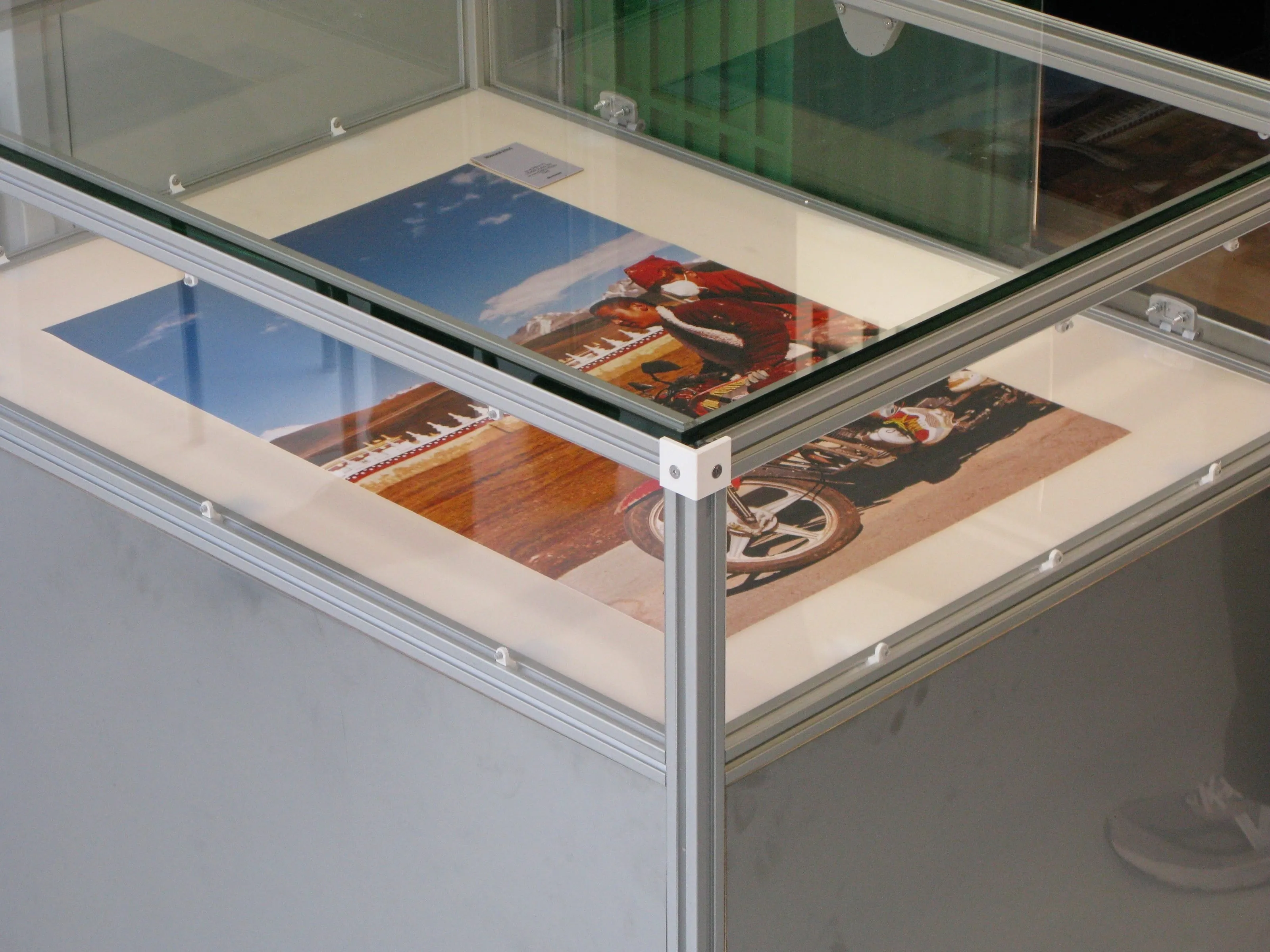 Glass vitrine top with photo prints laid on milk glass, Analogue store Zeedijk