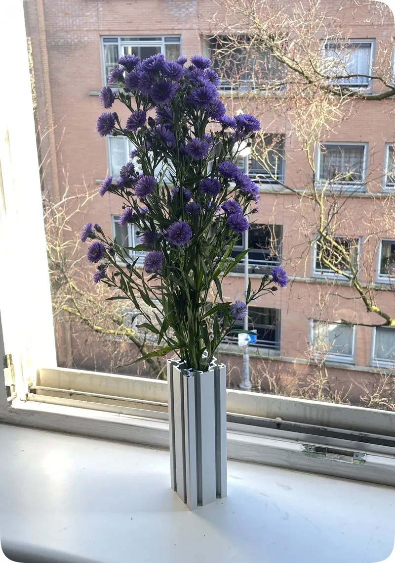 Type 660 vase with purple flowers on a windowsill
