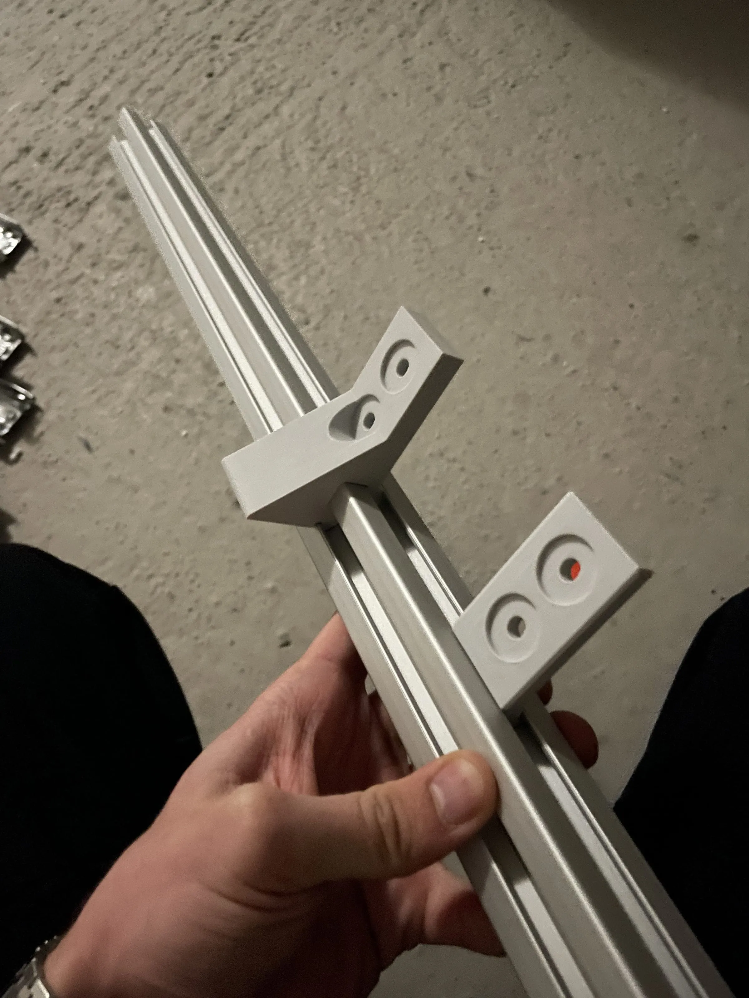 Hand holding an aluminium extrusion with mounted connector blocks, Analogue store Zeedijk