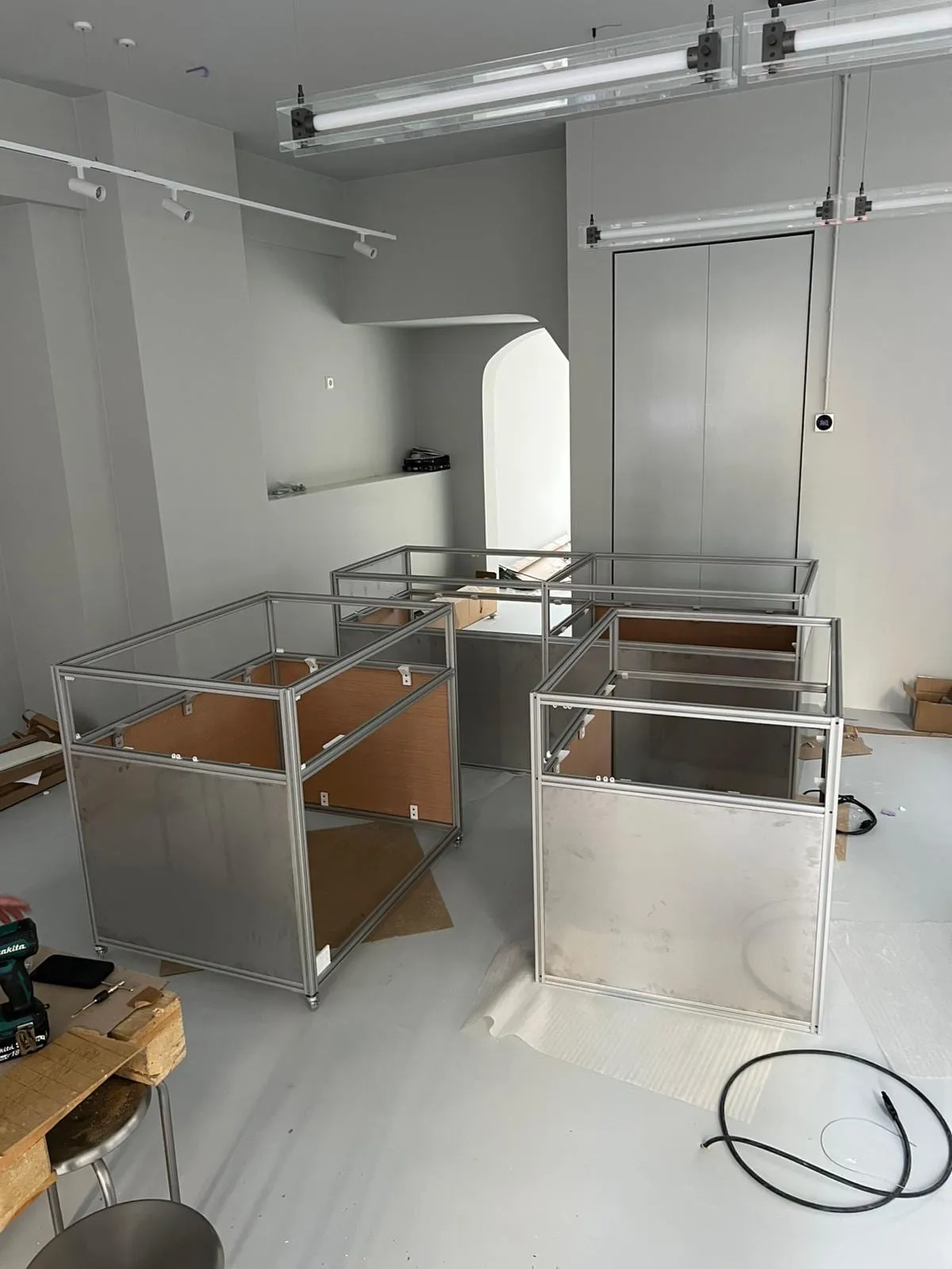 Unfinished vitrines with frames and glass in the workshop, Analogue store Zeedijk