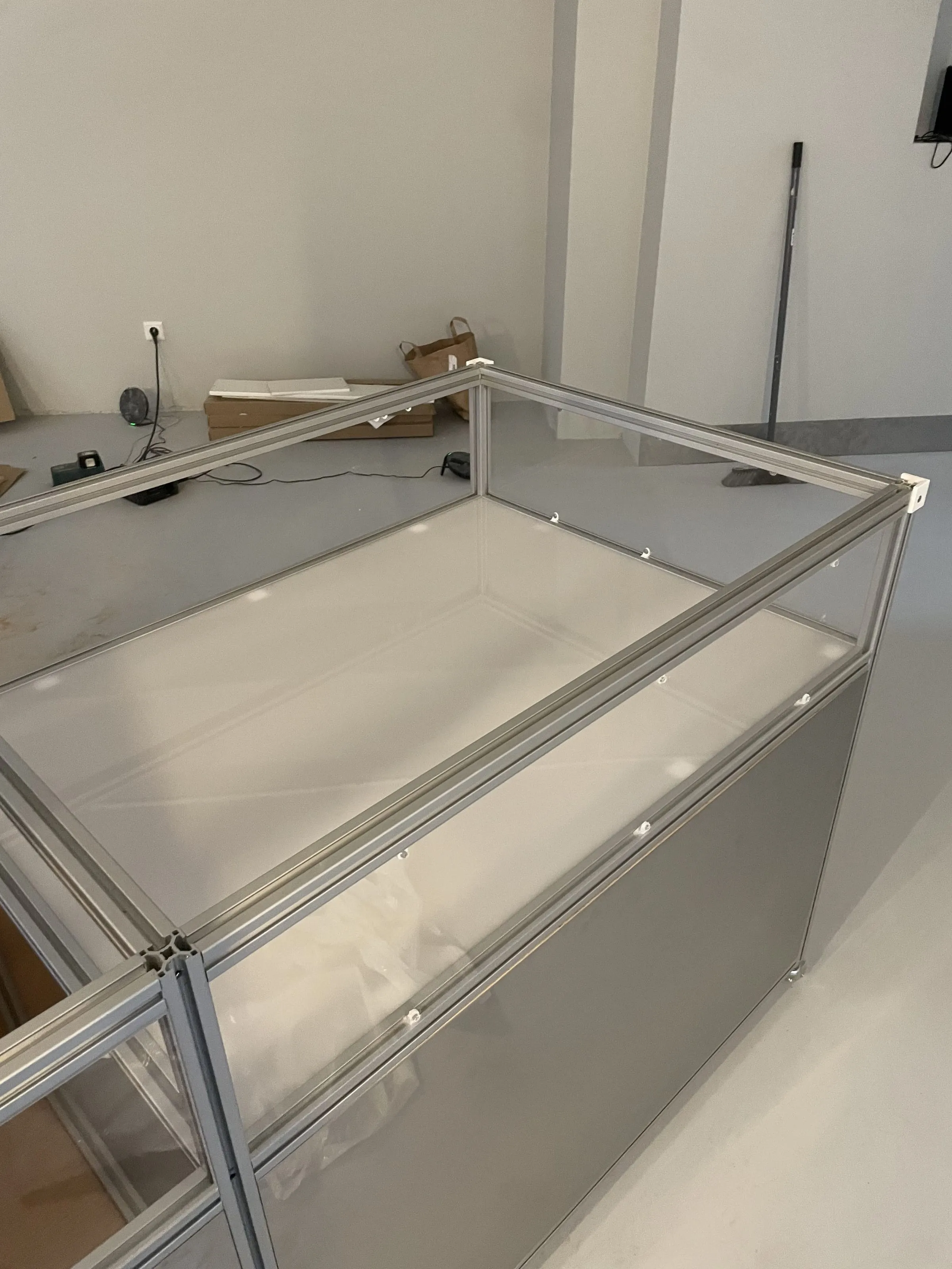 Half assembled vitrine frame with milk glass panels, Analogue store Zeedijk