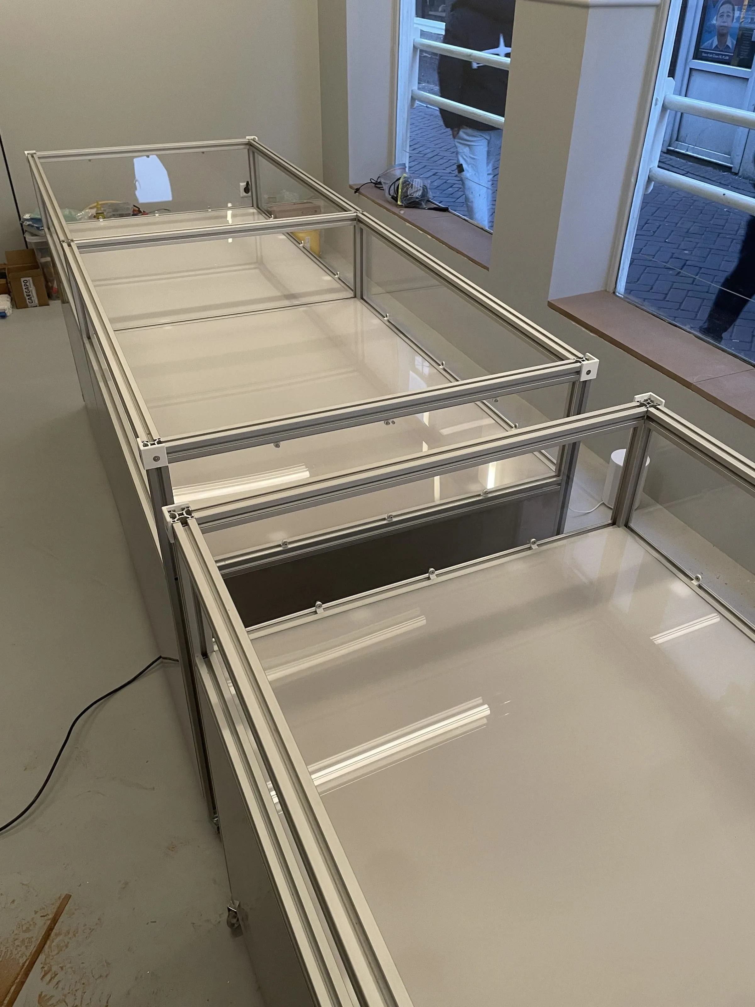 Two vitrine frames under construction in the empty shop, Analogue store Zeedijk